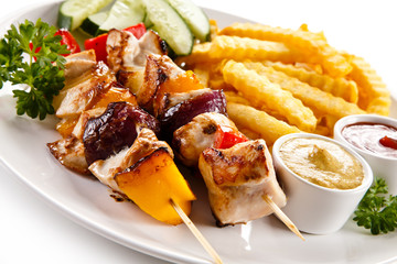 Grilled meat, French fries and vegetables 