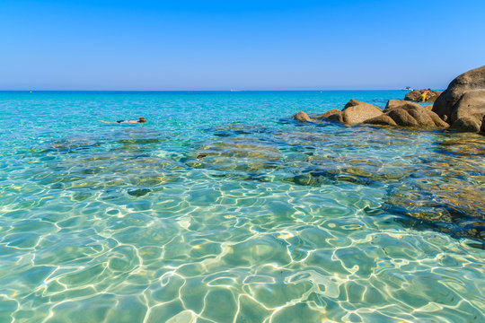 Crystal clear sea water with rocks on Saleccia beach, Corsica island, France