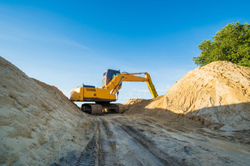 Obraz premium excavator in action, the sand