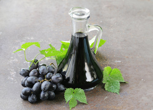 balsamic vinegar in a glass jug with fresh grapes
