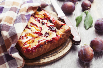 Pie with plums on the table