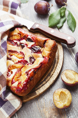 Pie with plums on the table