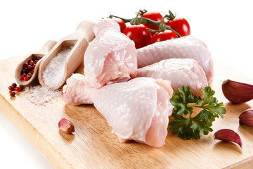 Raw chicken legs on cutting board 