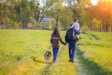 Happy family walking with dog