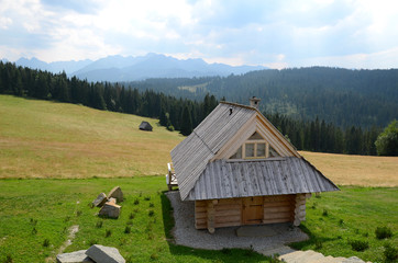 Mountain landscape with wooden house
