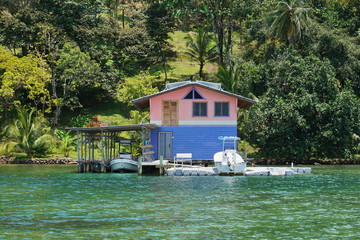 Coastal home with dock and boat house over water