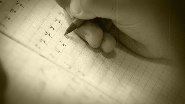 Old film effect: a pupil makes his first steps in writing digits