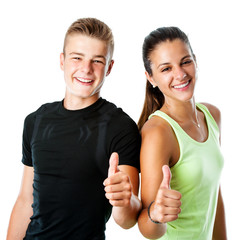 Teen fitness couple doing thumbs up.