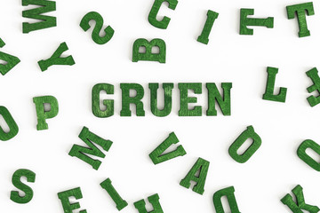 Series "Color": Background made from yellow wooden letters, German word  "Gruen/green" in the center