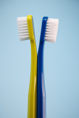 Two soft toothbrushes on blue background