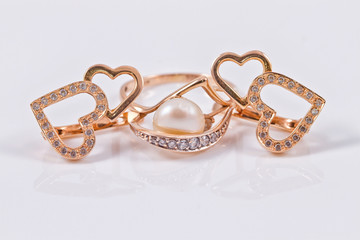 set of gold earrings and gold ring