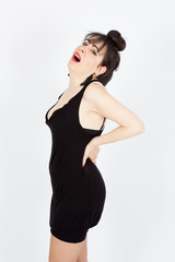 Fototapeta premium Beautiful woman doing different expressions in different sets of clothes: backache