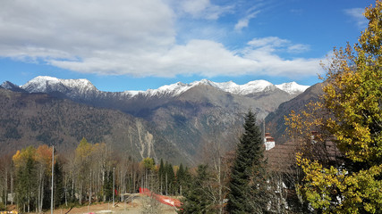 Осень в горах Кавказа, снег на вершинах, желтые листья на деревьях, Красная Поляна, Россия  © lana4ka
