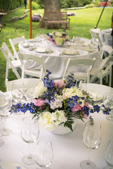 Fototapeta na wymiar Flower arrangements on tables with glasses.