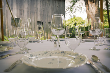 Table with glasses and silverware in garden