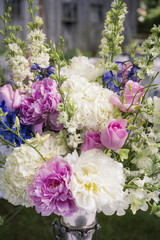 Flowery arrangement with roses in silver vase