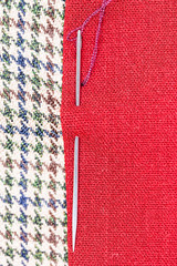 needle sews two pieces of fabric