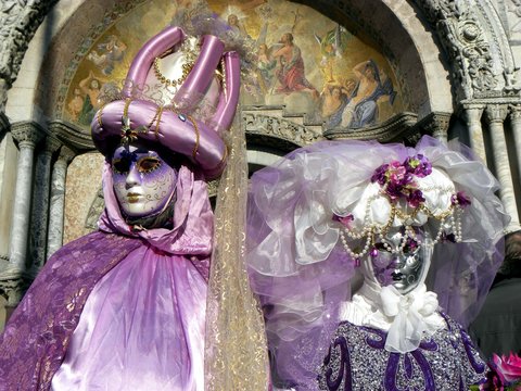 Male and female masks in St. Mark's Square in Venice, Italy