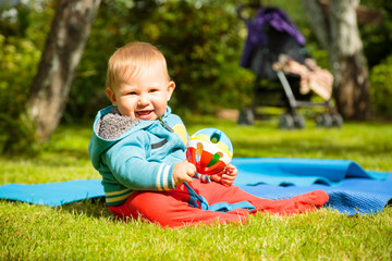 Happy Baby Playing with Ball Outdoors