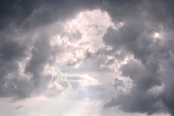 Naklejka na ściany i meble Sunlight Breaking Between Cumulonimbus Clouds