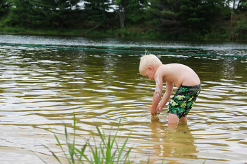 Young Child PLaying Outside in Lake