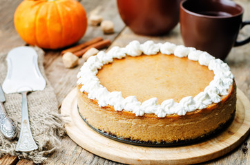 pumpkin cheesecake decorated with whipped cream