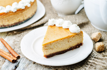 pumpkin cheesecake decorated with whipped cream