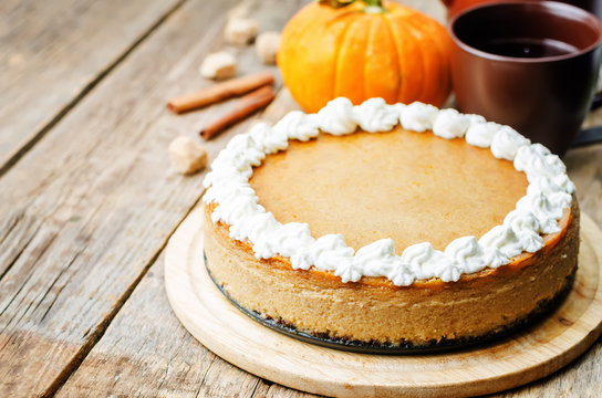 pumpkin cheesecake decorated with whipped cream
