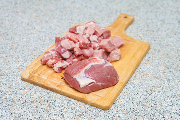 meat chopped into small pieces on a cutting board