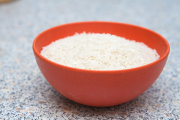 uncooked rice in a cup on the table