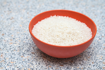 uncooked rice in a cup on the table