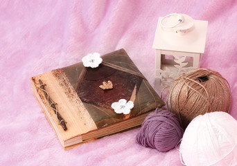 Pink background with skein, book and Lantern