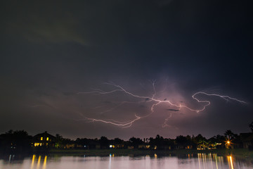 Heat lightning over a suburban neighborhood lake