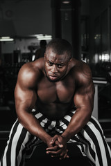 Naklejka na ściany i meble Weight training African doing bodybuilding