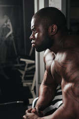 Fototapeta na wymiar Weight training African doing bodybuilding