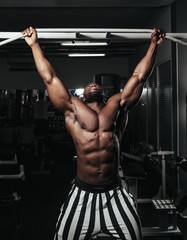 Fototapeta na wymiar Weight training African doing bodybuilding