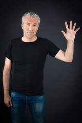 Naklejka premium Handsome man doing different expressions in different sets of clothes: waving