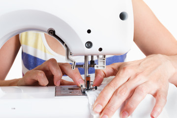 Women's hands behind her sewing