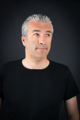 Handsome man doing different expressions in different sets of clothes: thinking