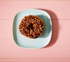 Chocolate pecan donut on plate