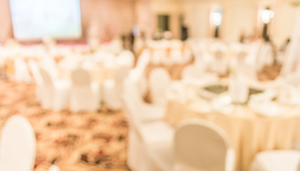 blurred image of Large dining table set for wedding, dinner or f