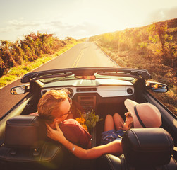 Happy Couple Driving in Convertible