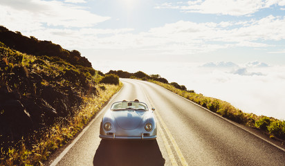 Coupe Driving on Country Road in Vintage Sports Car