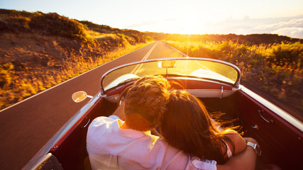 Romantic Couple Driving on Beautiful Road at Sunset