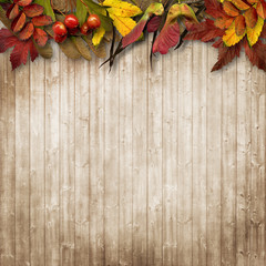 Autumn leaves border on vintage wooden background