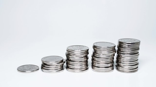 1080p time lapse animated video of silver coins being stacked up. Works well in reverse too.