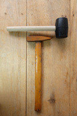 Steel hammer and Rubber Hammer on wooden background
