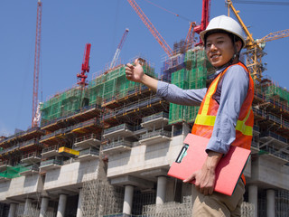 Construction worker holding a red file