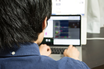 Asian engineer writing a programme on a computer
