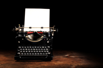 Old vintage typewriter with blank paper